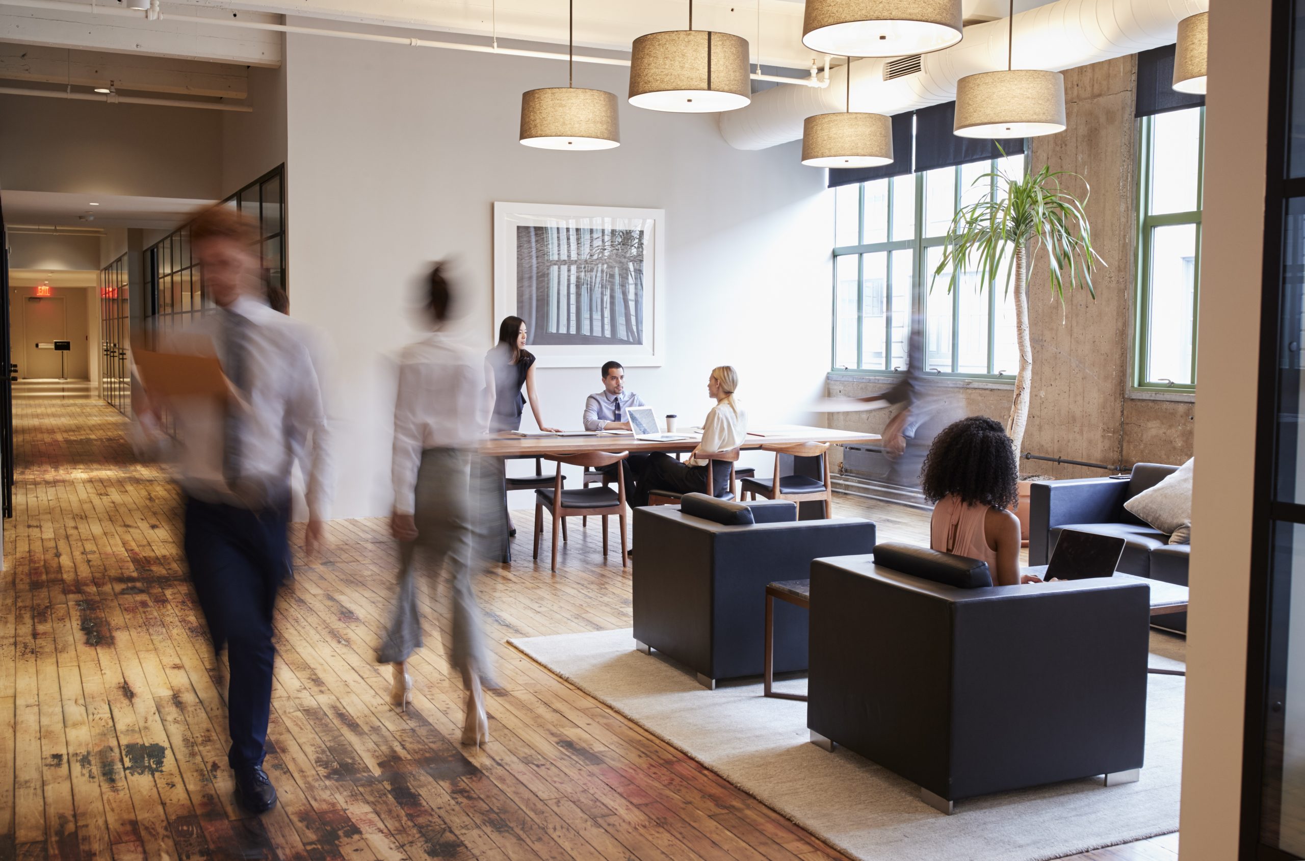 Business people at work in a busy luxury office space