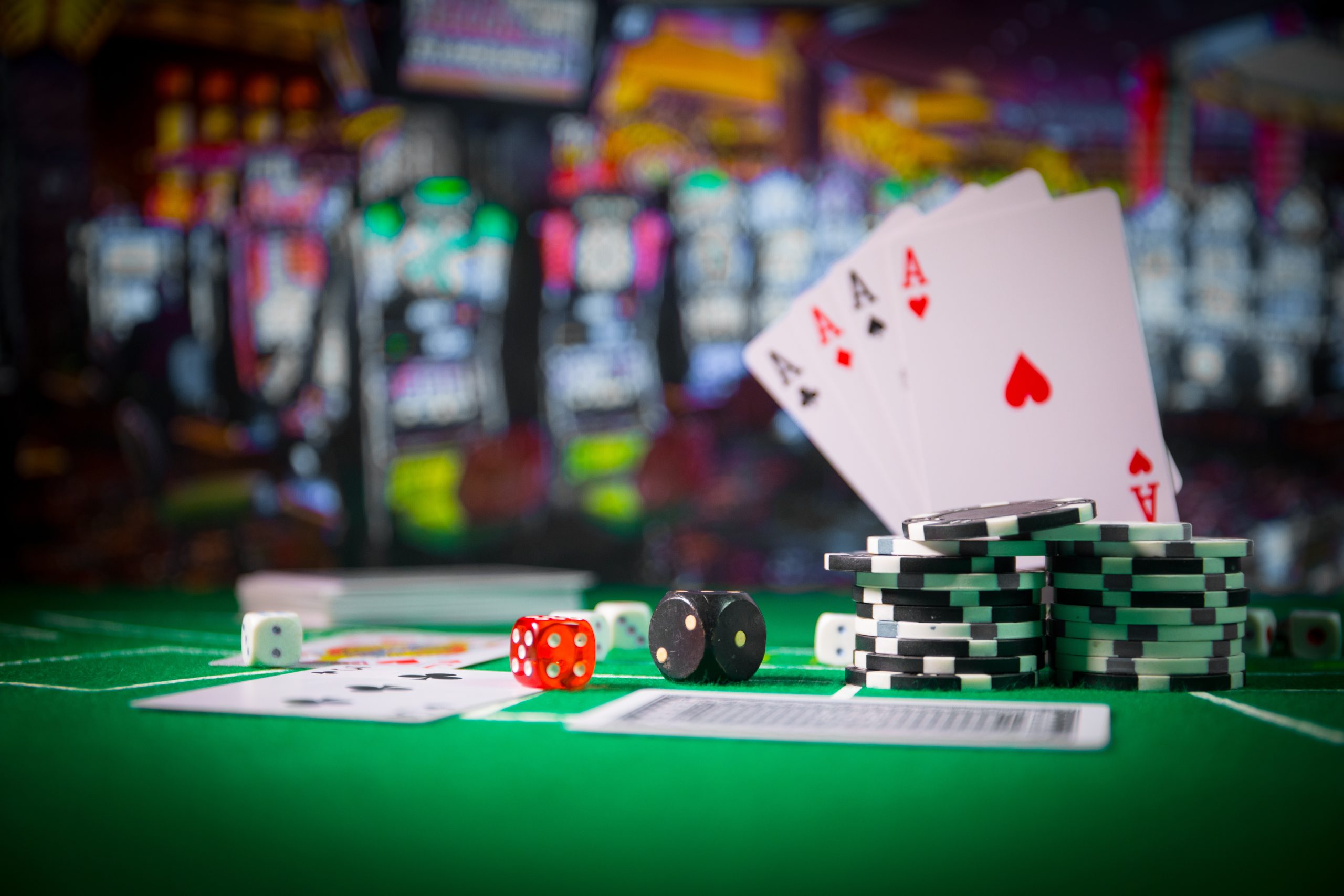 Cards and chips on green felt casino table. Abstract background with copy space. Gambling, poker, casino and cards games theme. Casino elements on green. Selective focus