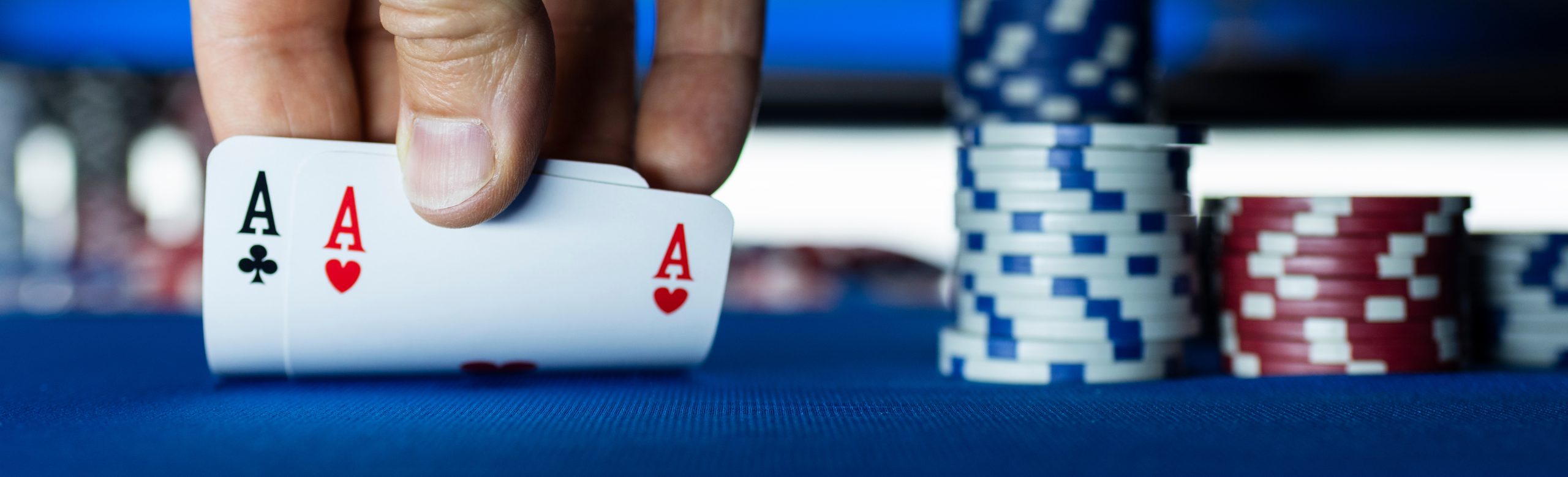 Hold 'em Texas poker tournament at casino: a player is holding two ace cards