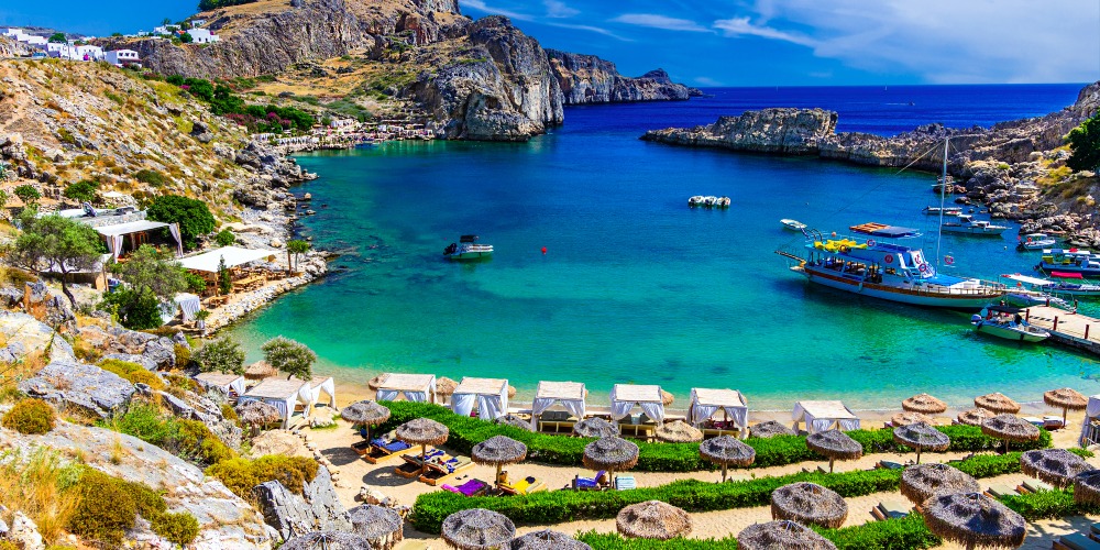 Lindos city on Rhodes island, Greece. St Paul's Bay Beach and the Acropolis, on Rhodos Island, Greece at Aegean Sea, Europe