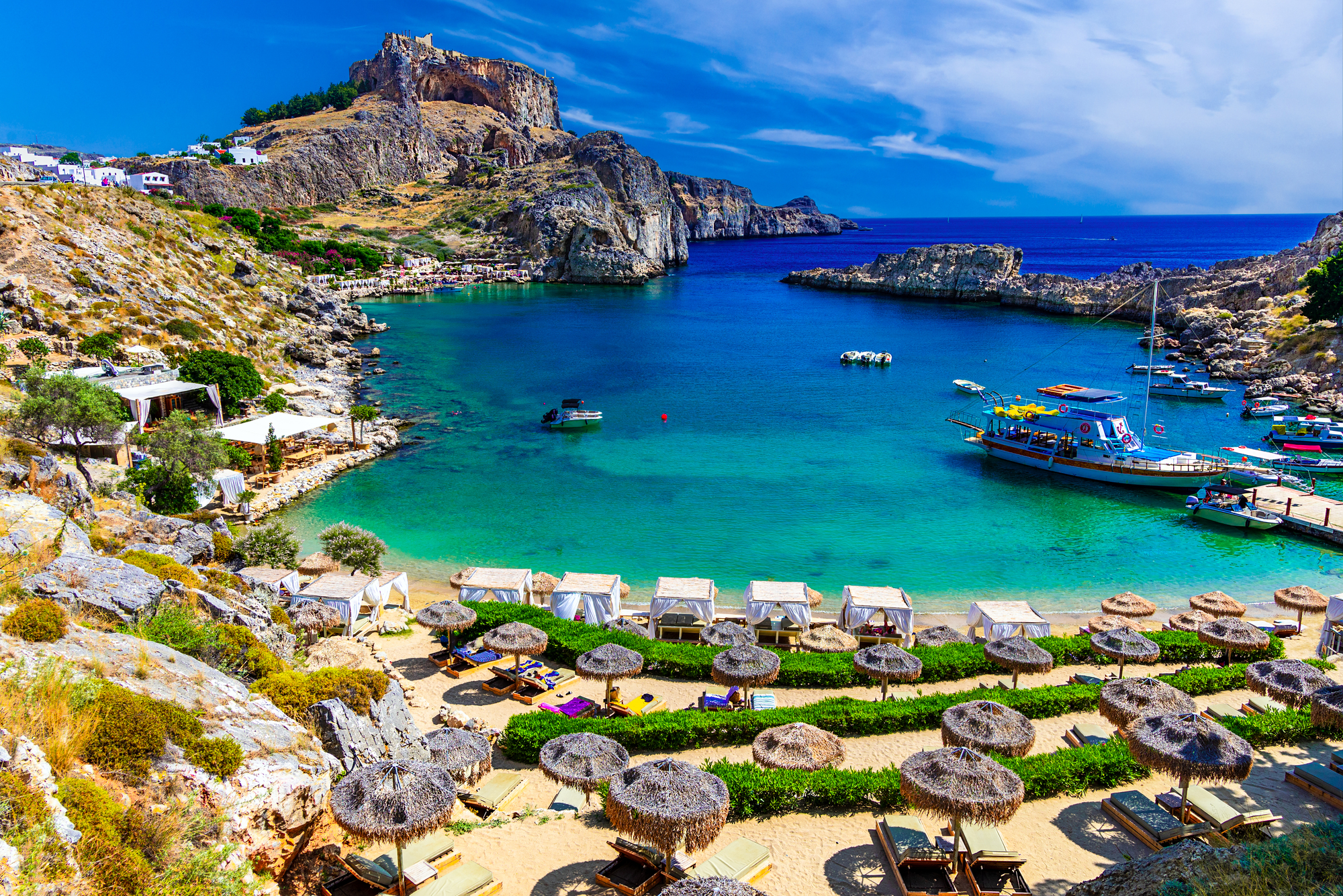 Lindos city on Rhodes island, Greece. St Paul's Bay Beach and the Acropolis, on Rhodos Island, Greece at Aegean Sea, Europe